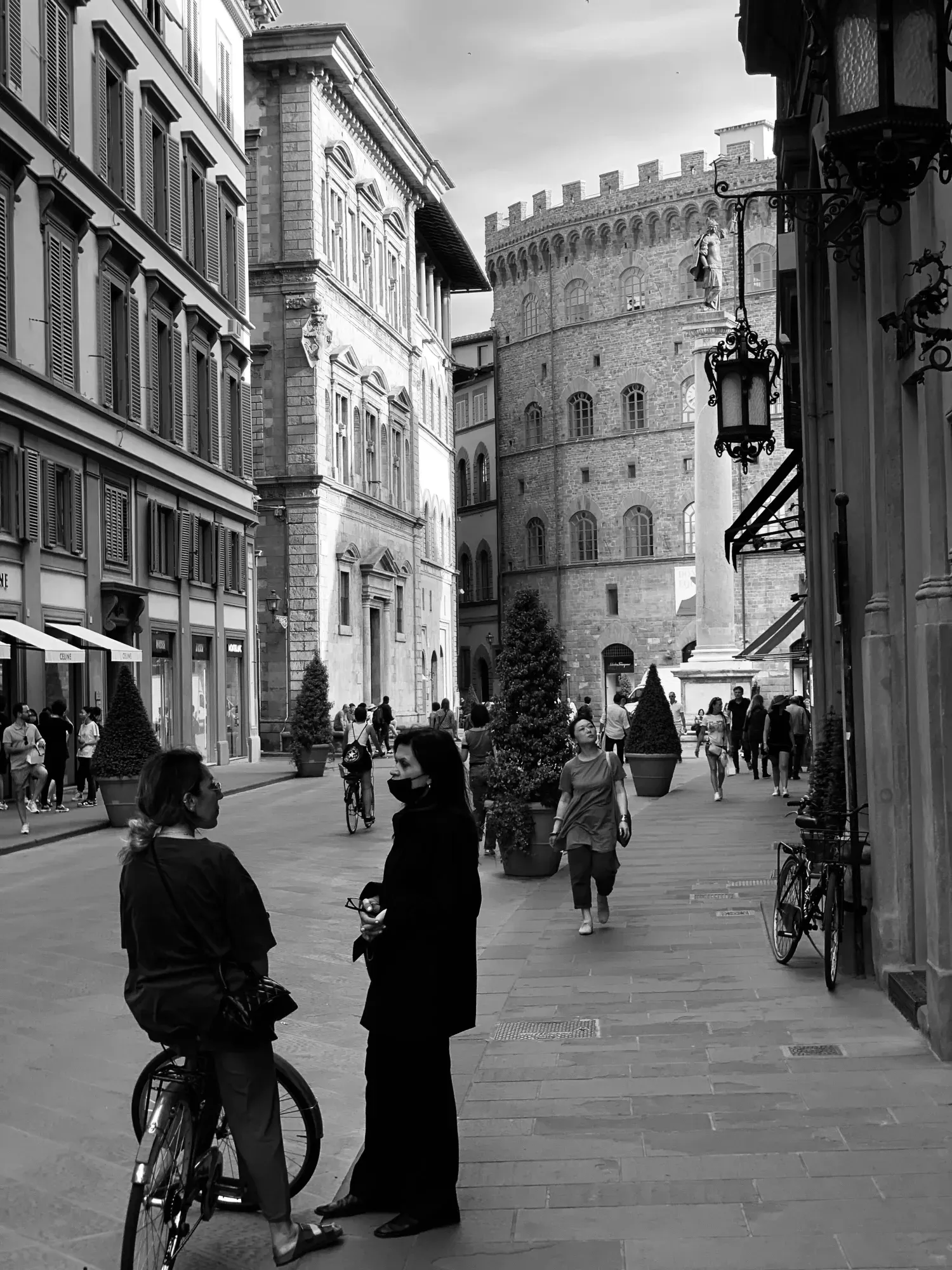 A couple of people standing next to each other on a street